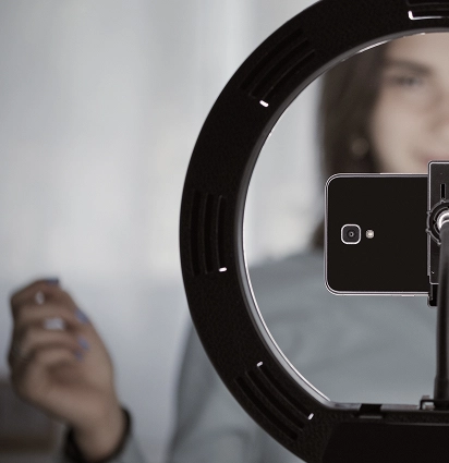 Phone filming setup with ring light.